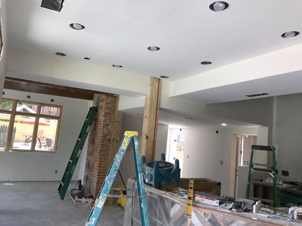 inside of a home with white walls in the process of being painted